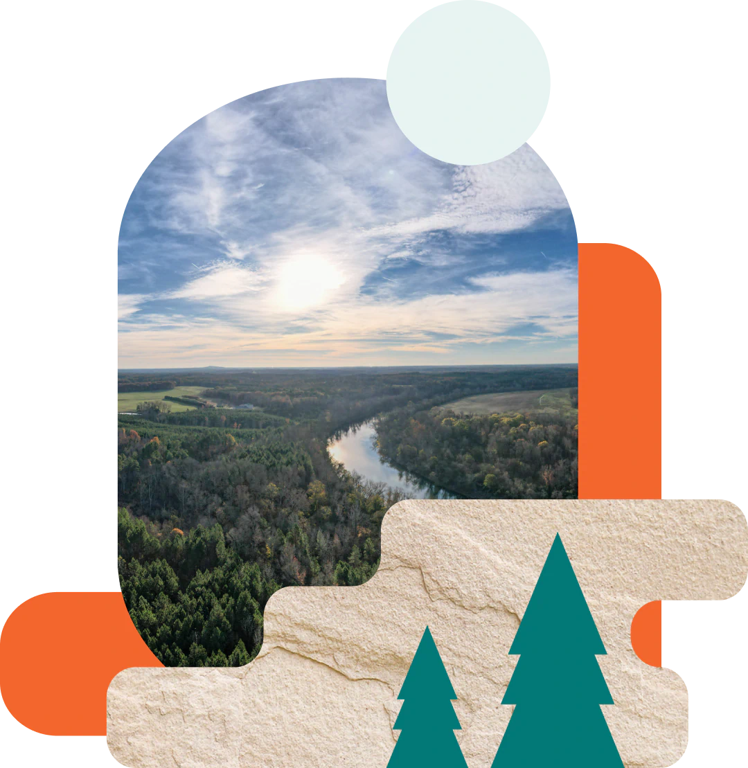Desktop_Contact_Us_Find_Your_Dental_Home Aerial view of a river winding through a forest under a cloudy sky, with abstract geometric shapes and illustrated pine trees in the foreground.