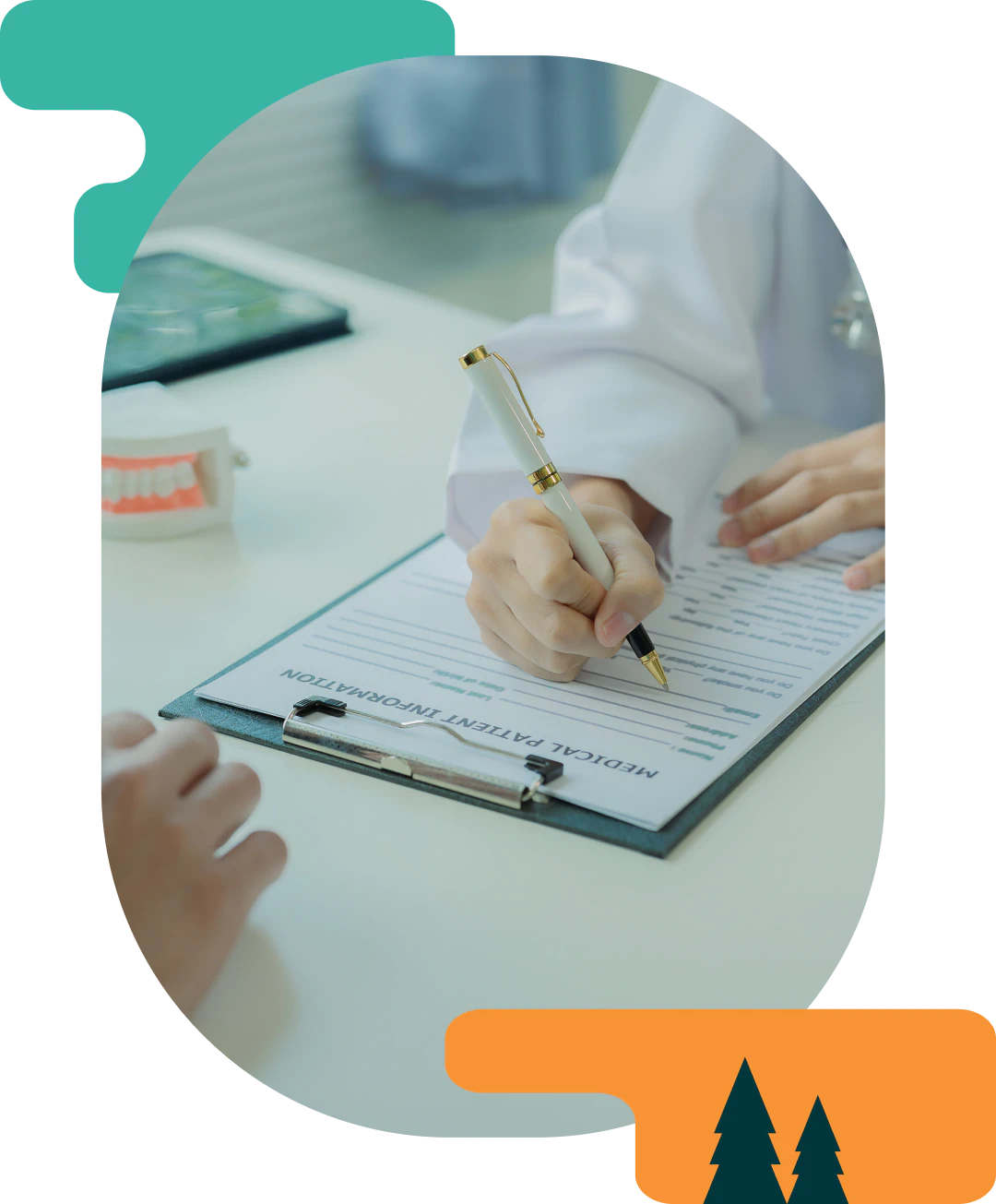 A person fills out a medical patient information form on a clipboard, with a dental model nearby and another person's hand visible across the table.